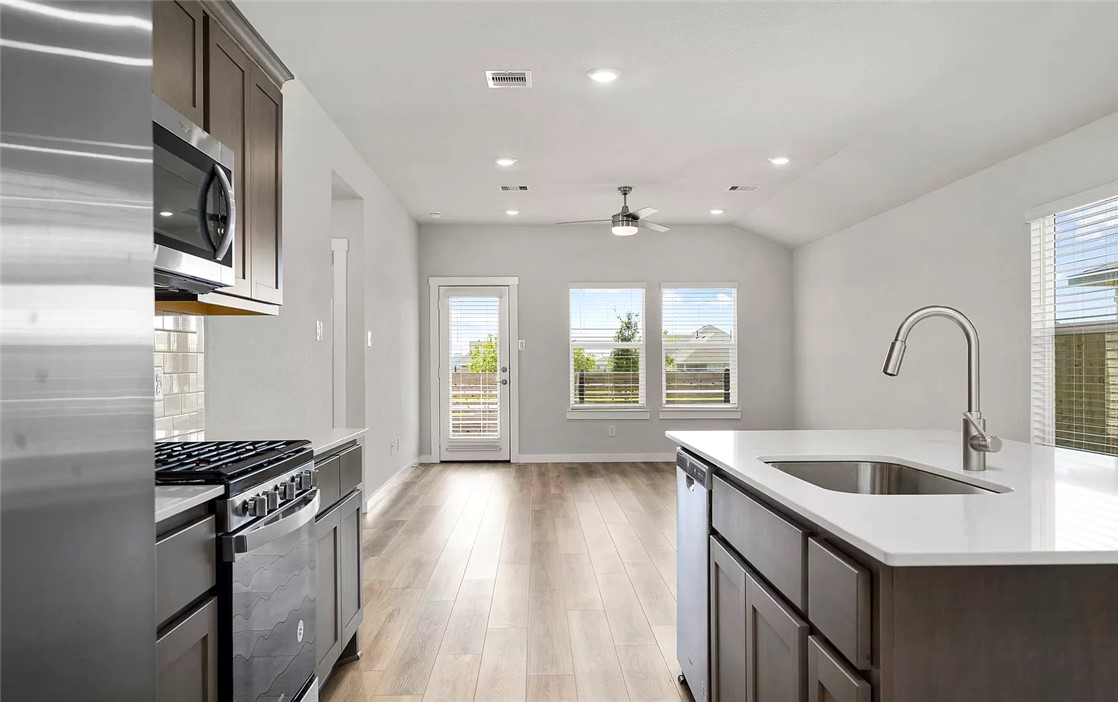 925 Kickapoo Lane College Station, TX 77845 - Photo 5 of 20 a kitchen with stainless steel appliances granite countertop a sink and a stove