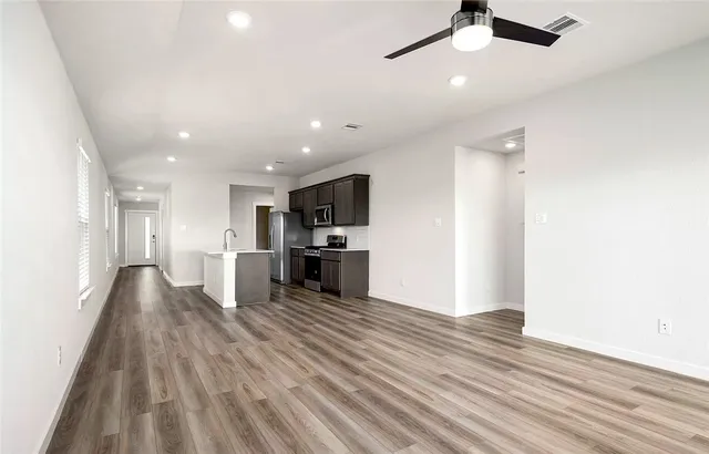 a view of kitchen with refrigerator microwave and stove