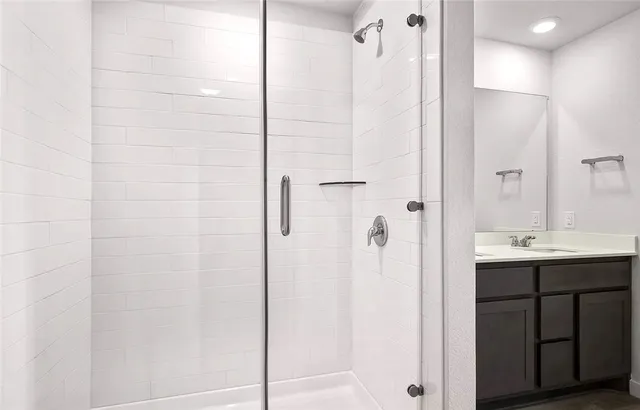 a bathroom with a shower and a sink