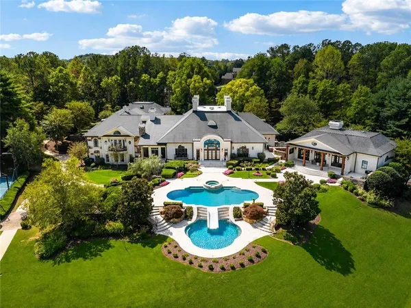a aerial view of a house with swimming pool and big yard