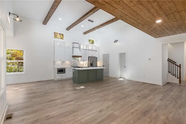 a kitchen with a sink stove and microwave