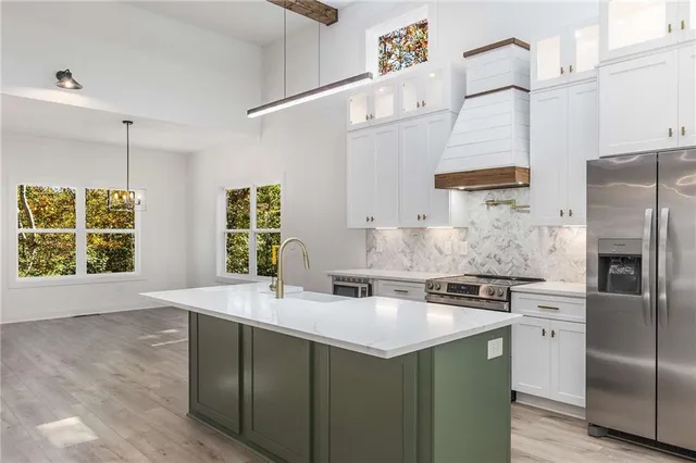 a kitchen that has a sink and a stove in it