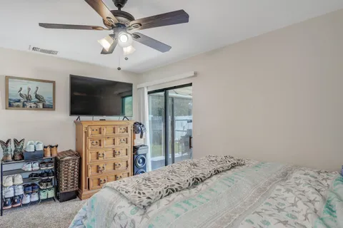 a bathroom with a granite countertop sink a toilet and a mirror
