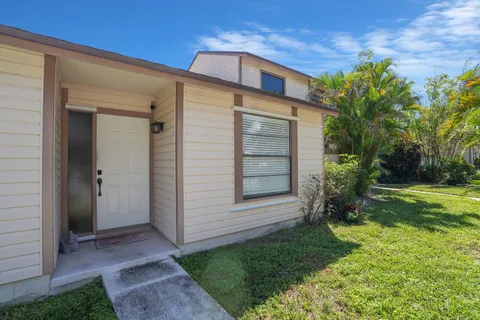a view of house with backyard and garden