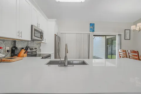 a kitchen with stainless steel appliances a refrigerator and a stove