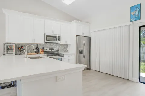 a kitchen with stainless steel appliances a refrigerator stove and microwave