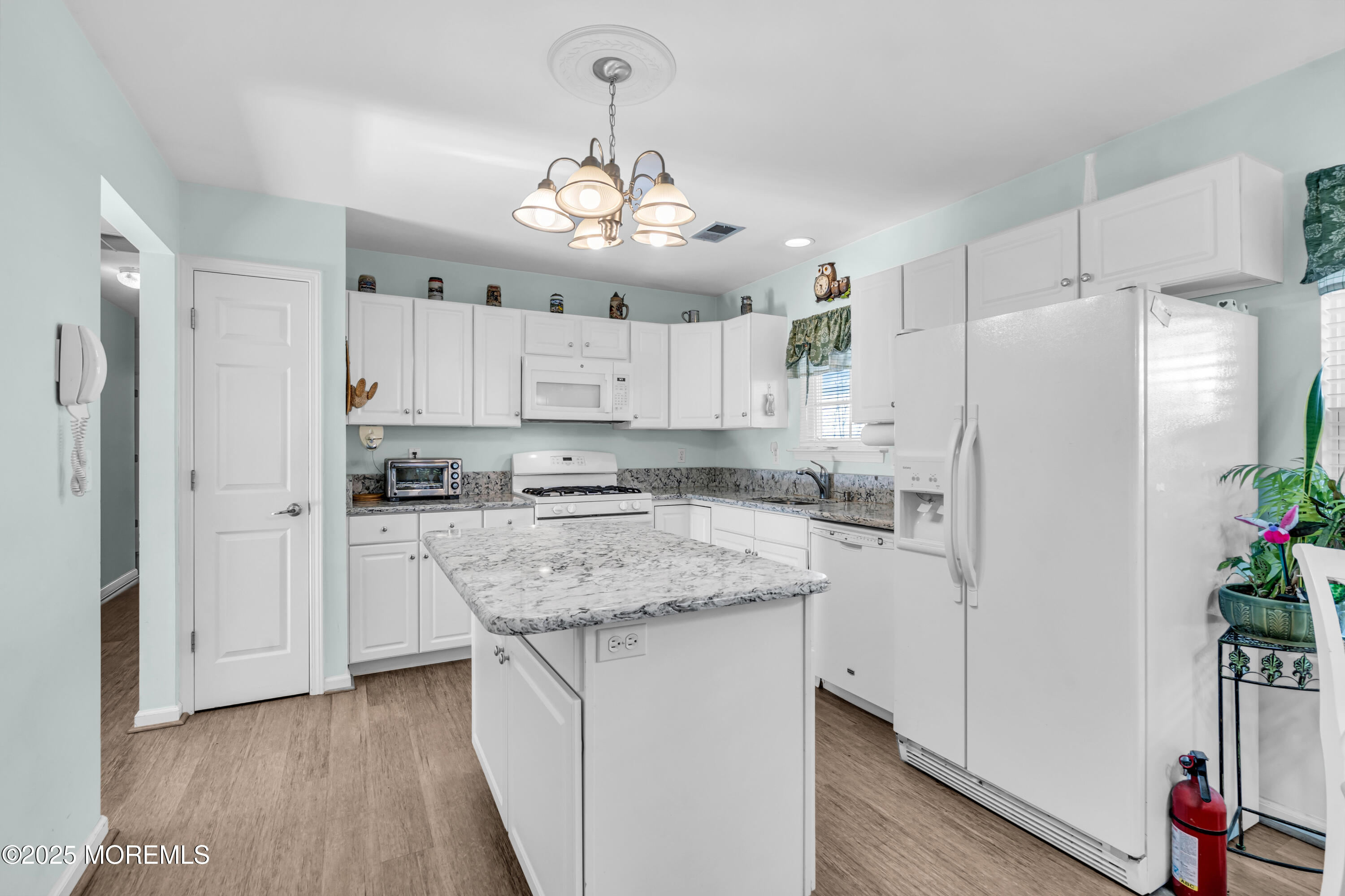14 Pine Valley Road Lakewood, NJ 08701 - Photo 16 of 56 a kitchen with stainless steel appliances a refrigerator a stove a sink dishwasher and white cabinets with wooden floor