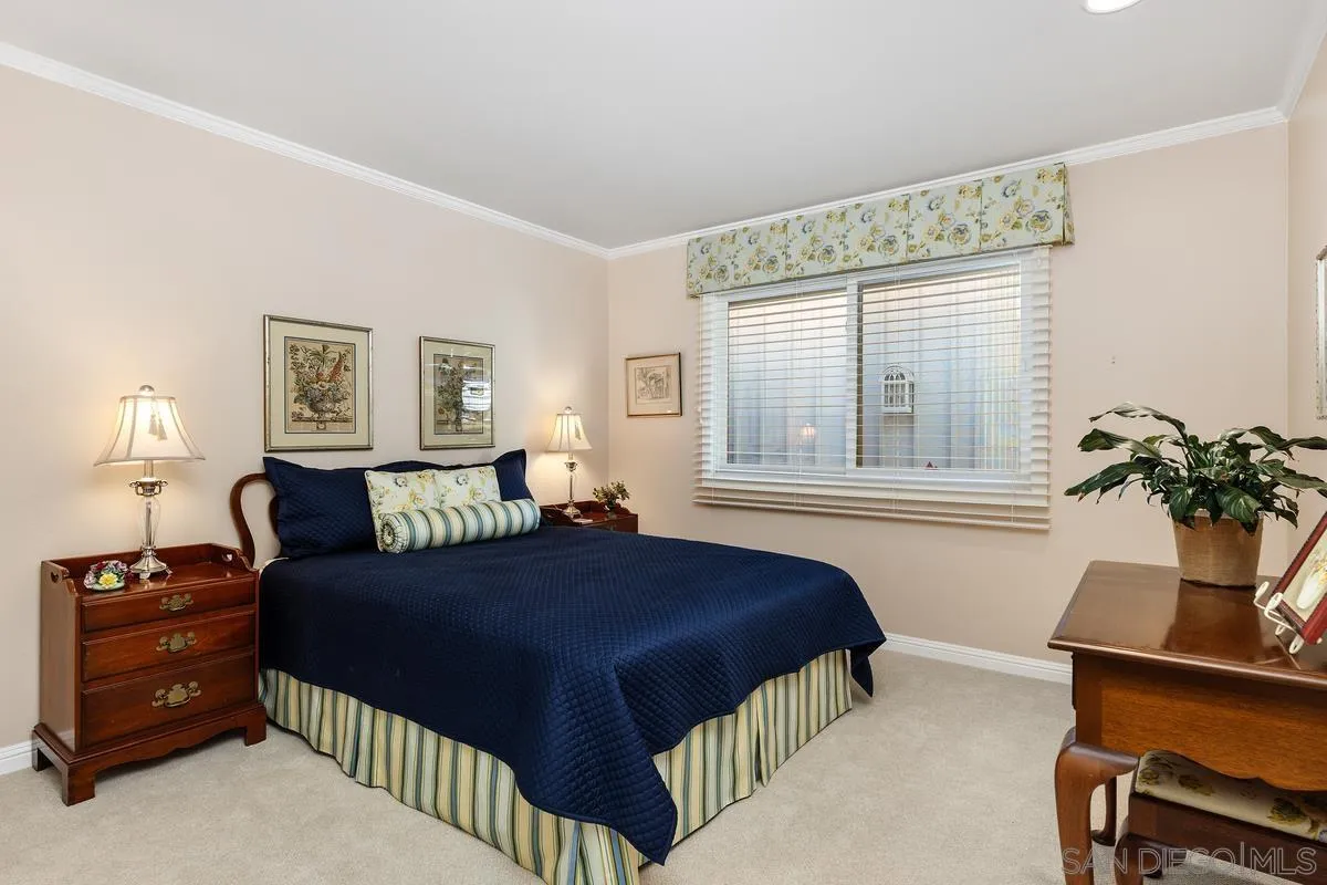 5625 Caminito Isla La Jolla, CA 92037 - Photo 15 of 29 a bedroom with a bed and a potted plant