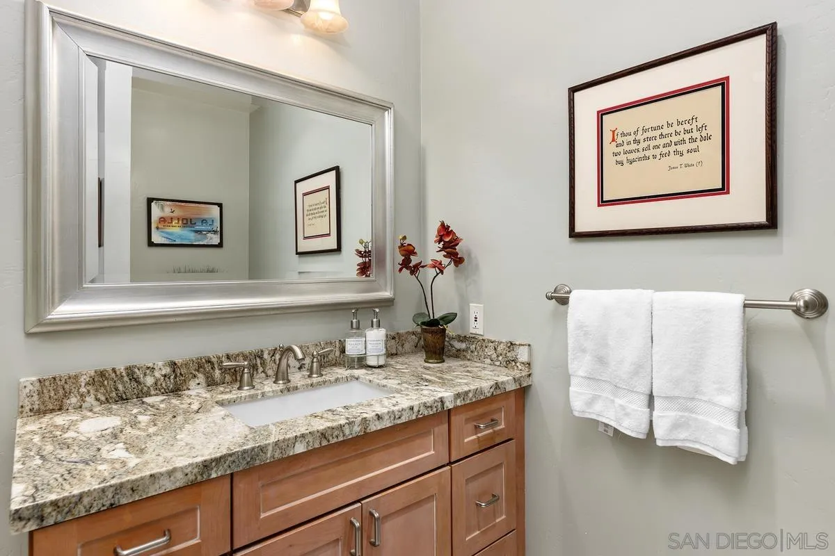 5625 Caminito Isla La Jolla, CA 92037 - Photo 17 of 29 a bathroom with a granite countertop sink and a mirror