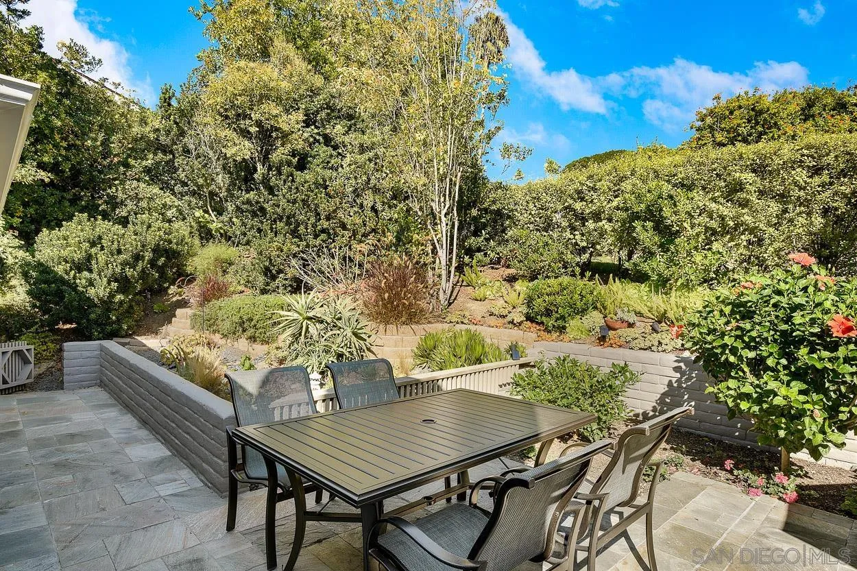 5625 Caminito Isla La Jolla, CA 92037 - Photo 22 of 29 a view of a backyard with table and chairs and potted plants