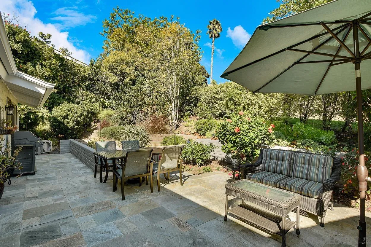 5625 Caminito Isla La Jolla, CA 92037 - Photo 3 of 29 a backyard of a house with table and chairs