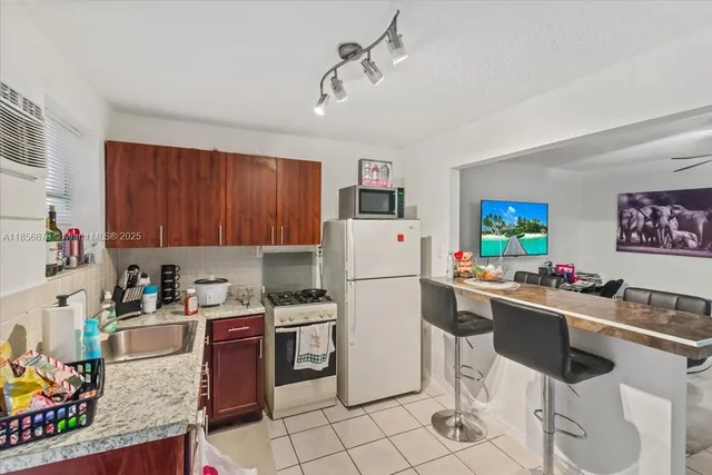a kitchen with a sink appliances and cabinets