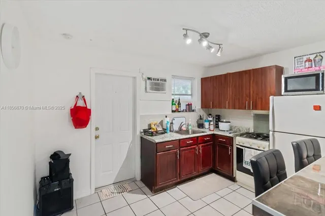 a kitchen with a sink a stove and cabinets