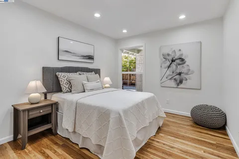 a bedroom with a bed and a painting on the wall
