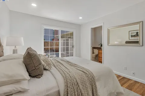 a bedroom with a bed and a large window
