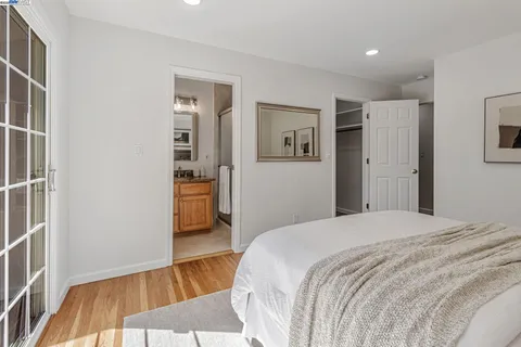 a bedroom with a bed and a view of kitchen