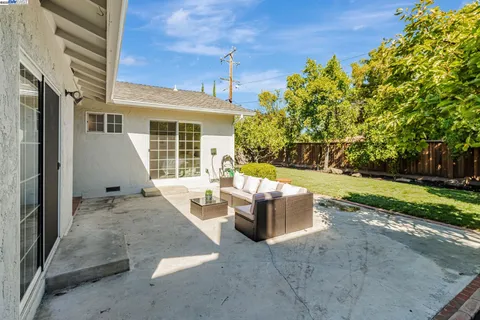 a view of a patio with couches and potted plants