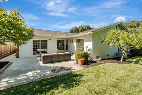 a house view with a sitting space and garden