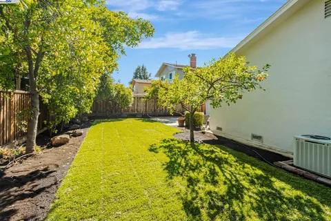a blue swimming pool is in a backyard of a house