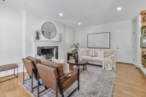 a living room with furniture a fireplace and a table