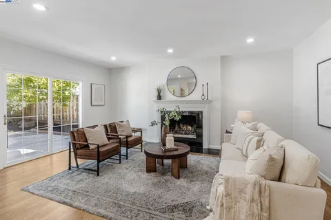 a living room with furniture a rug and a fireplace