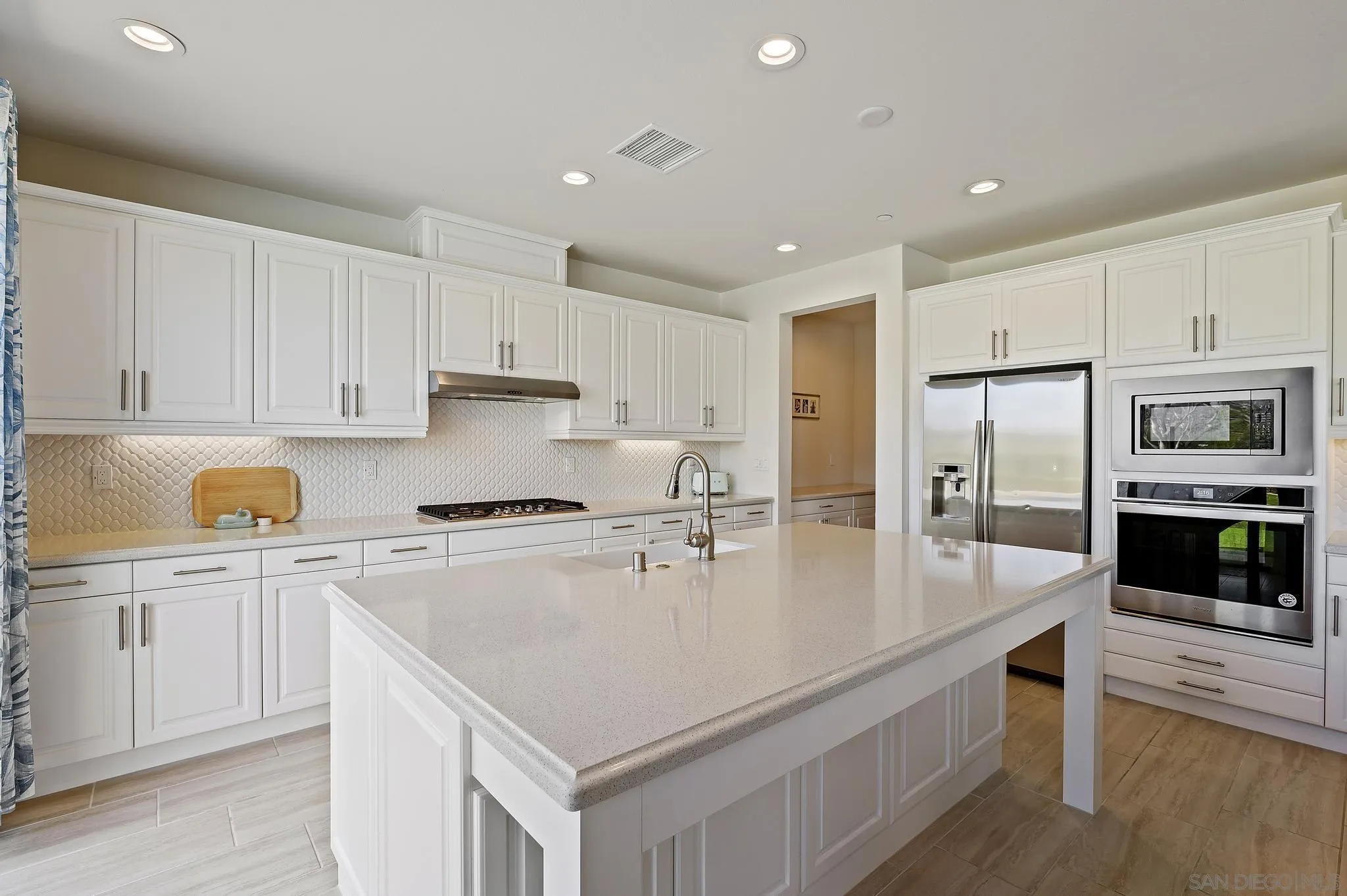 31657 Calle De Las Estrellas Bonsall, CA 92003 - Photo 11 of 30 a kitchen with stainless steel appliances granite countertop a stove refrigerator sink and cabinets