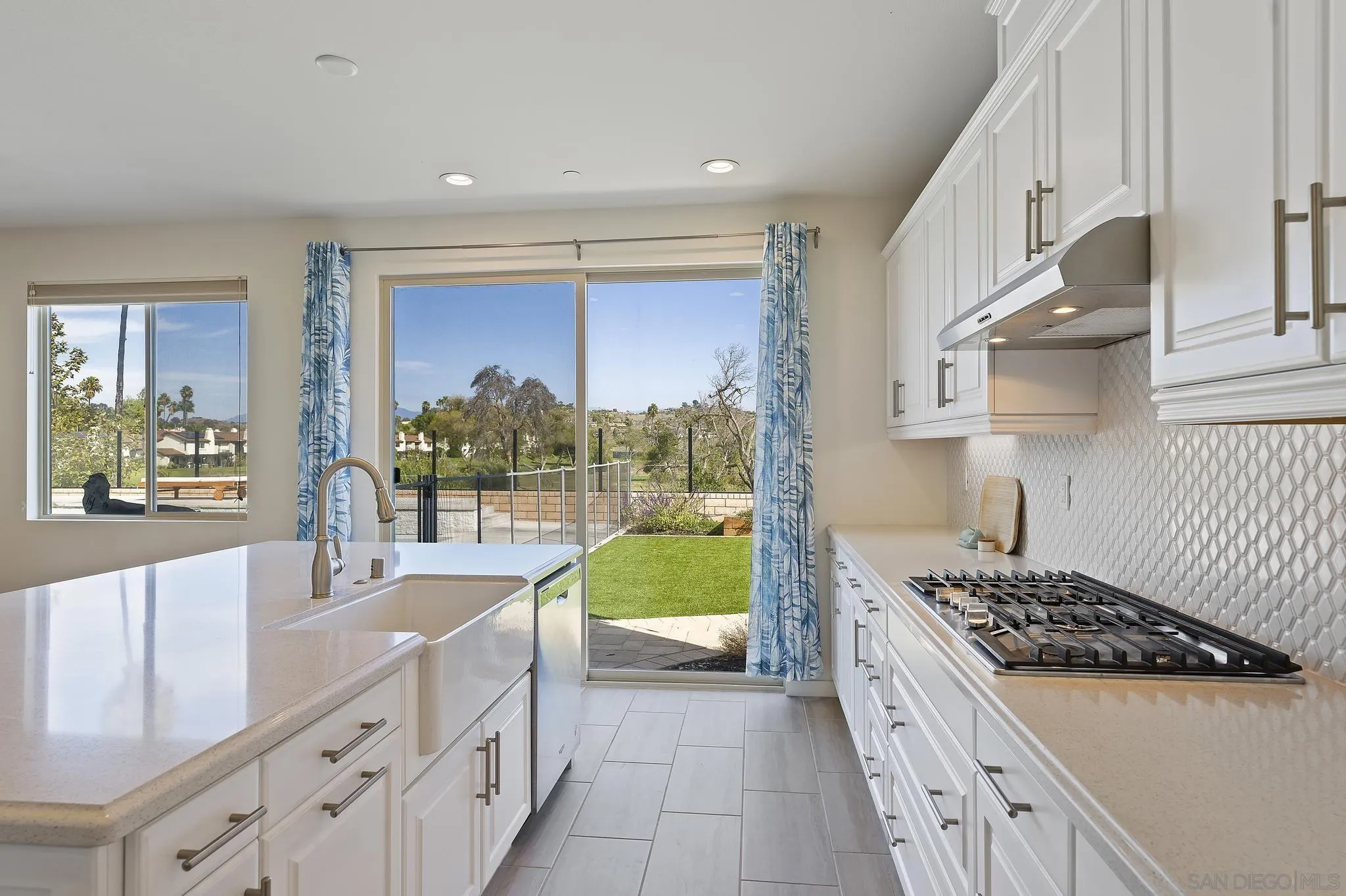 31657 Calle De Las Estrellas Bonsall, CA 92003 - Photo 13 of 30 a kitchen with a sink a stove and cabinets