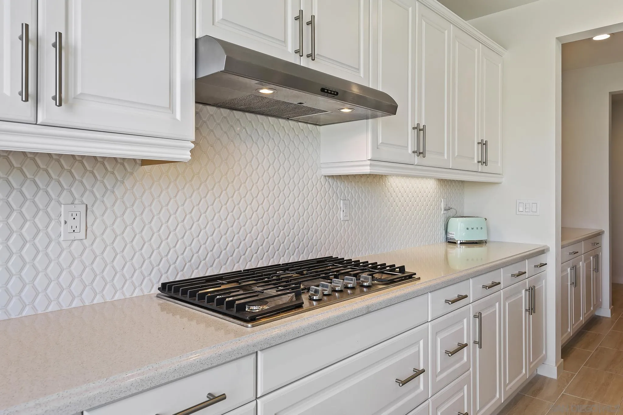 31657 Calle De Las Estrellas Bonsall, CA 92003 - Photo 15 of 30 a kitchen with white cabinets and appliances
