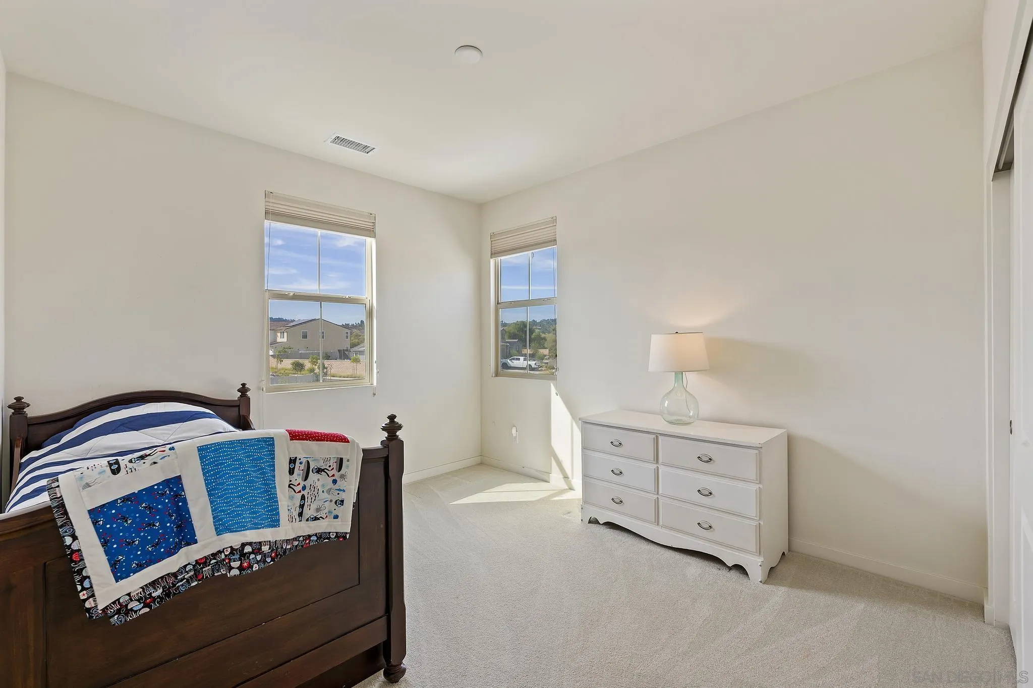31657 Calle De Las Estrellas Bonsall, CA 92003 - Photo 21 of 30 a bedroom with a bed and a dresser