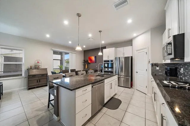 a large kitchen with a table and chairs