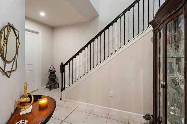 a living room with furniture a flat screen tv and a window