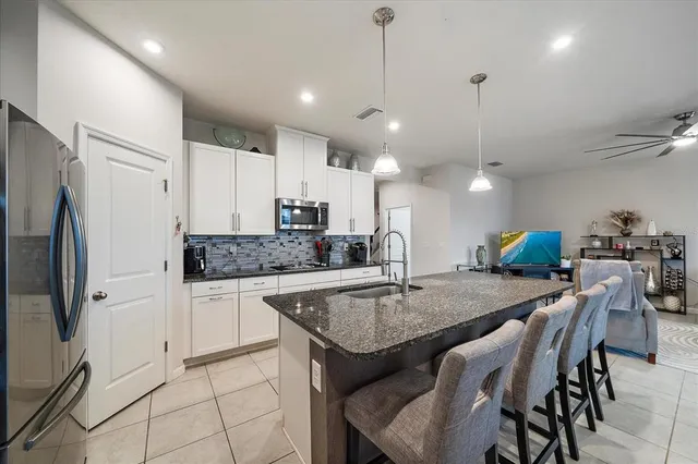 a kitchen with center island table and chairs in it