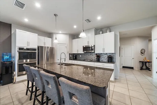 a kitchen with a sink a stove and cabinets