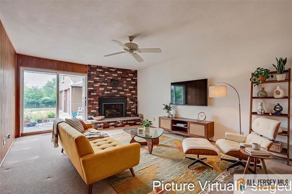 21 Tyndall Road Kendall Park, NJ 08824 - Photo 8 of 33 a living room with furniture ceiling fan and a fireplace