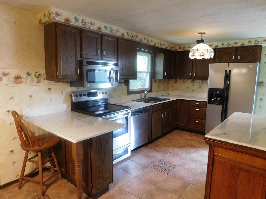 50 Bellvista Road Worcester, MA 01602 - Photo 5 of 20 a kitchen with cabinets a sink and appliances