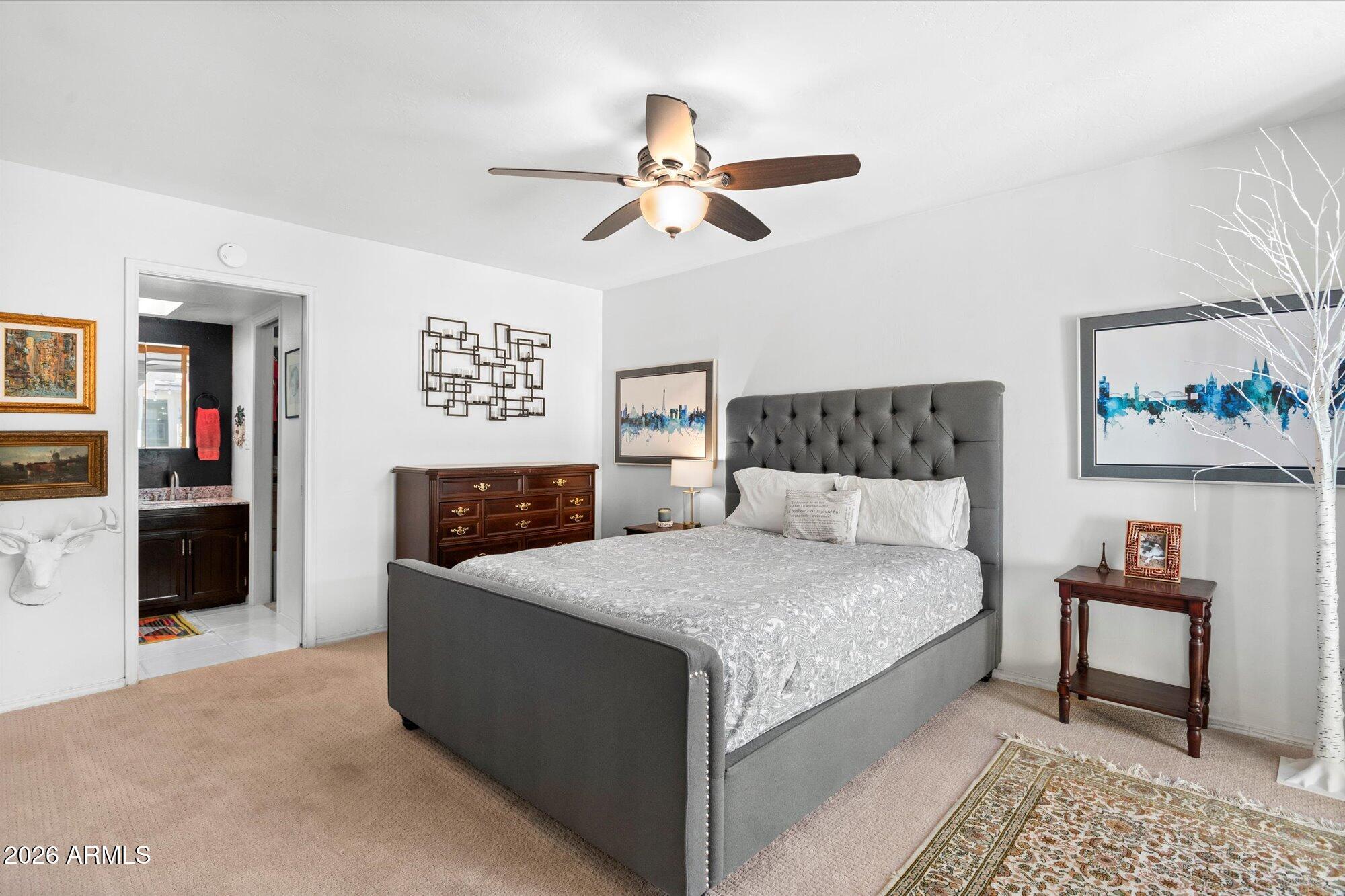 7005 North Barbados Place Phoenix, AZ 85021 - Photo 23 of 42 a bedroom with a bed and a chandelier