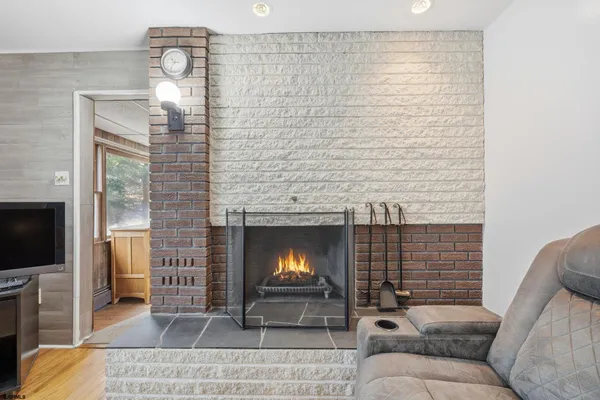 a living room with furniture fireplace and a flat screen tv