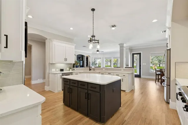 a kitchen with a sink stove and cabinets