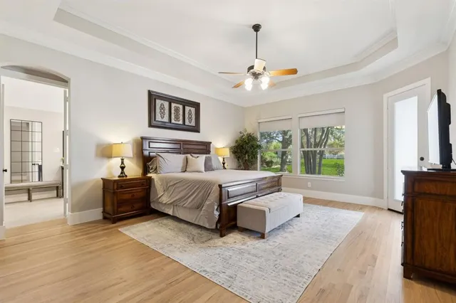 a bedroom with a large bed and a chandelier