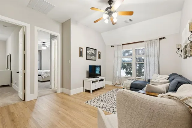 a bedroom with a bed and ceiling fan