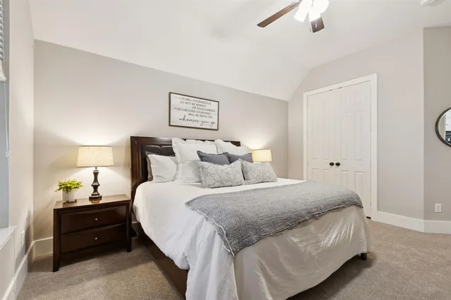 a bedroom with a bed and a night stand