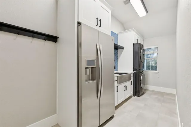 a kitchen with a refrigerator and a stove