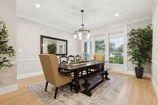 a dining room with furniture window and wooden floor