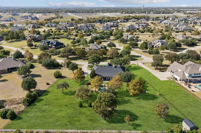 an aerial view of residential houses with outdoor space