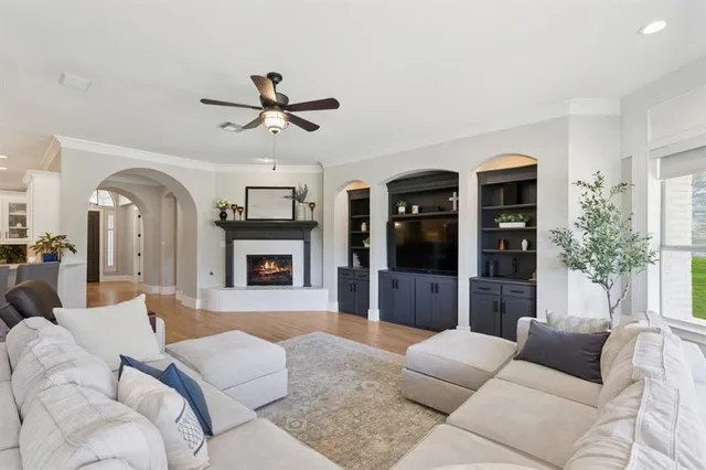 a living room with furniture ceiling fan and a fireplace