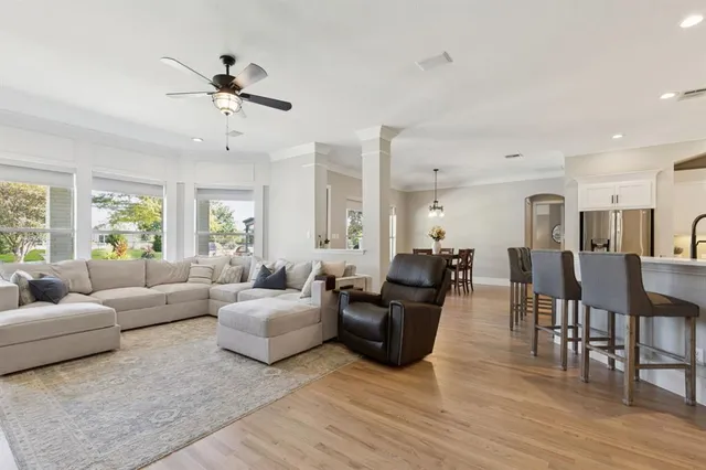 a living room with furniture and wooden floor