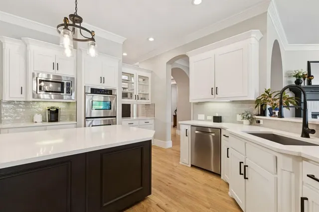 a kitchen with stainless steel appliances a sink stove and refrigerator