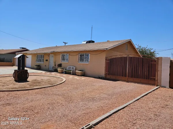 a backyard of a house with yard fire pit and barbeque oven