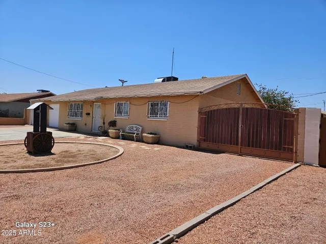 a backyard of a house with yard fire pit and barbeque oven