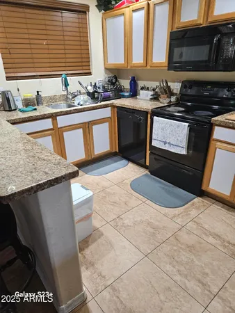 a kitchen with stainless steel appliances granite countertop a sink stove and microwave